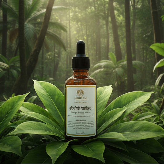 Bottle of hair oil with a dropper on a white surface